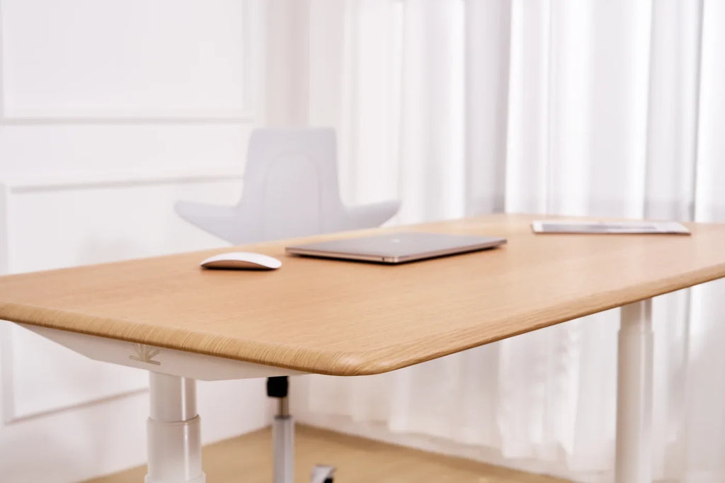 Oak standing desk in a bright home workspace