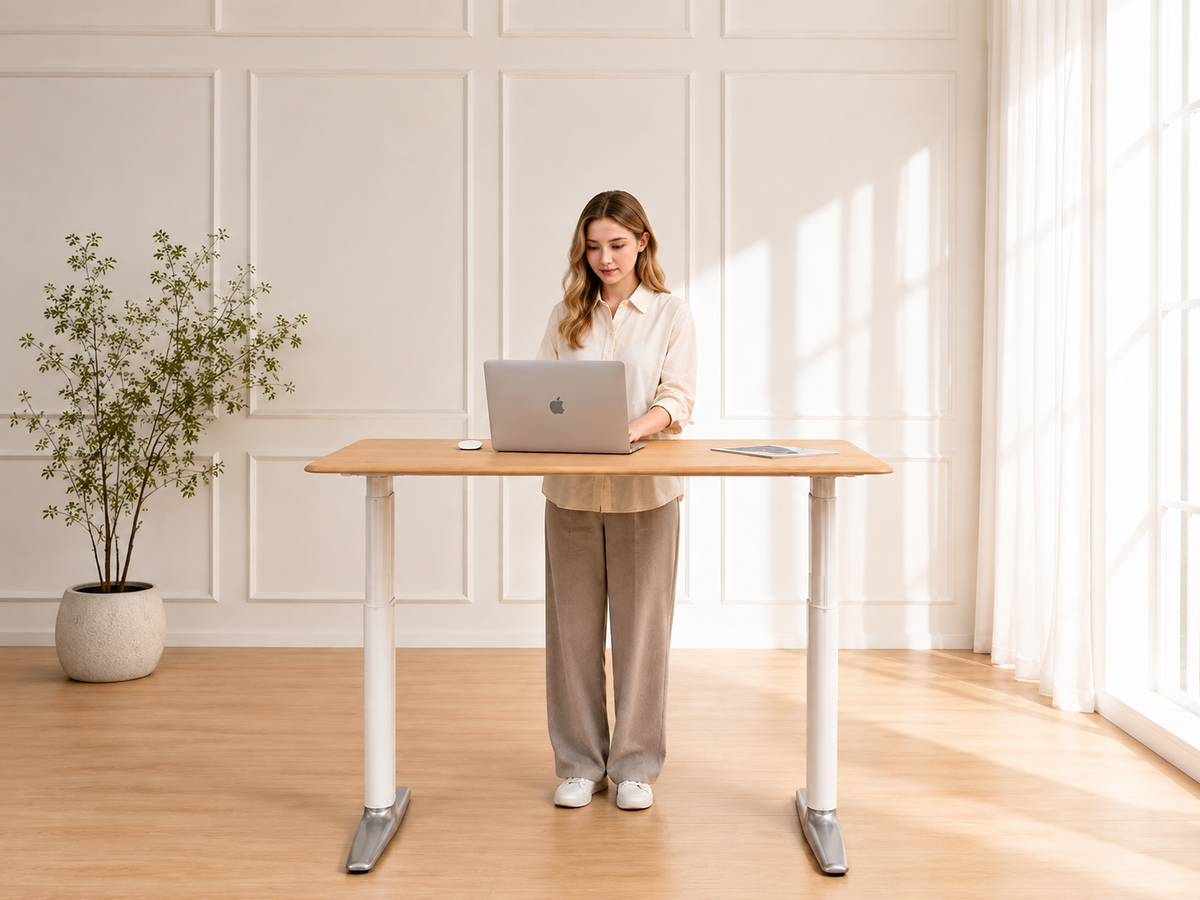 Woman working at the Essential One Standing Desk in a bright home office