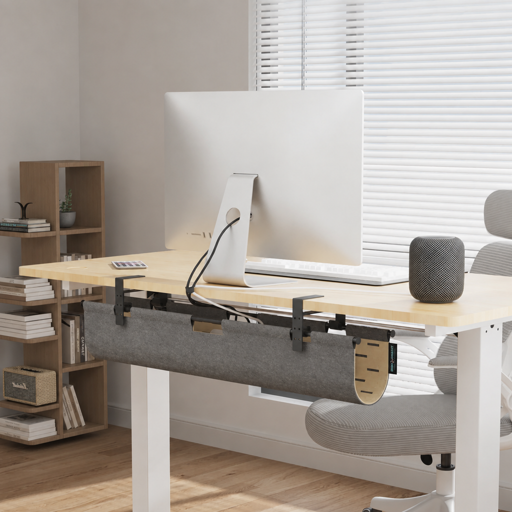 Gray felt privacy panel installed beneath a standing desk