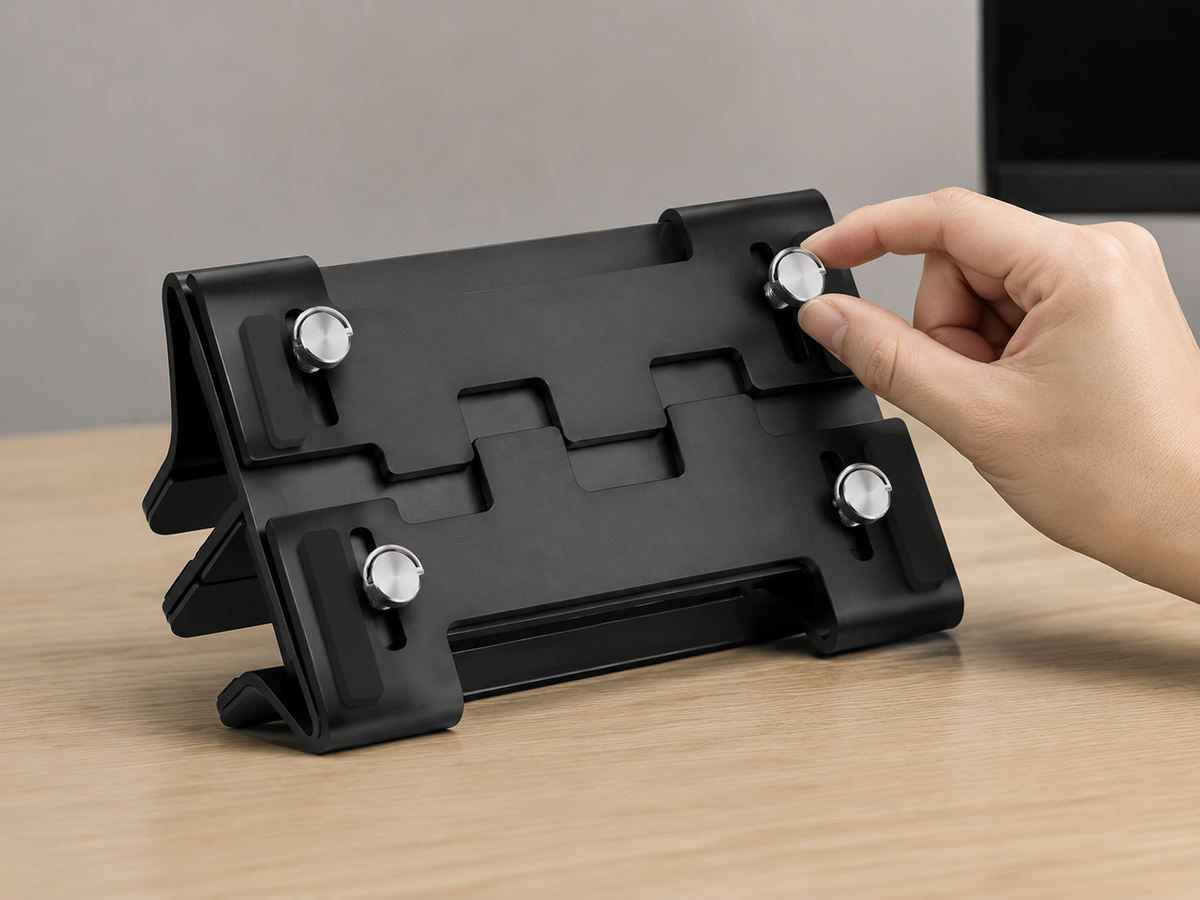 Hand adjusting the width of the aluminum laptop stand