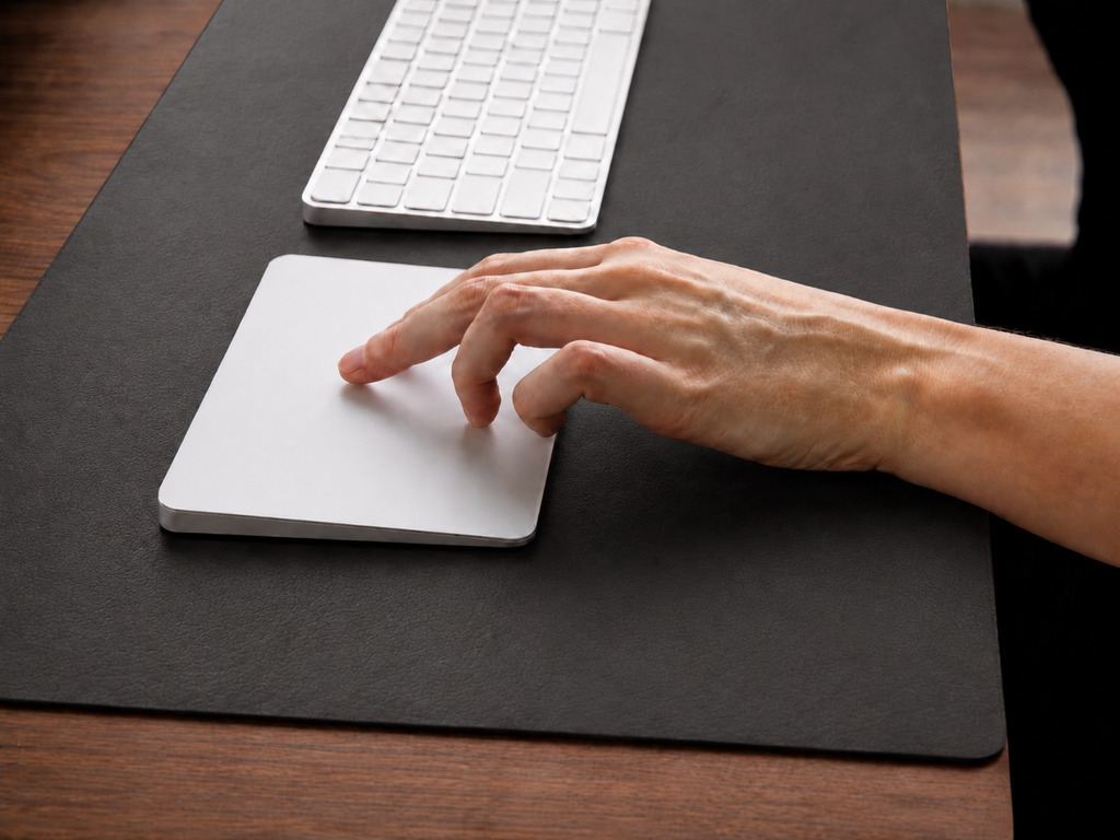 Napa Leather Desk Mat close-up with a hand using a white mouse and keyboard