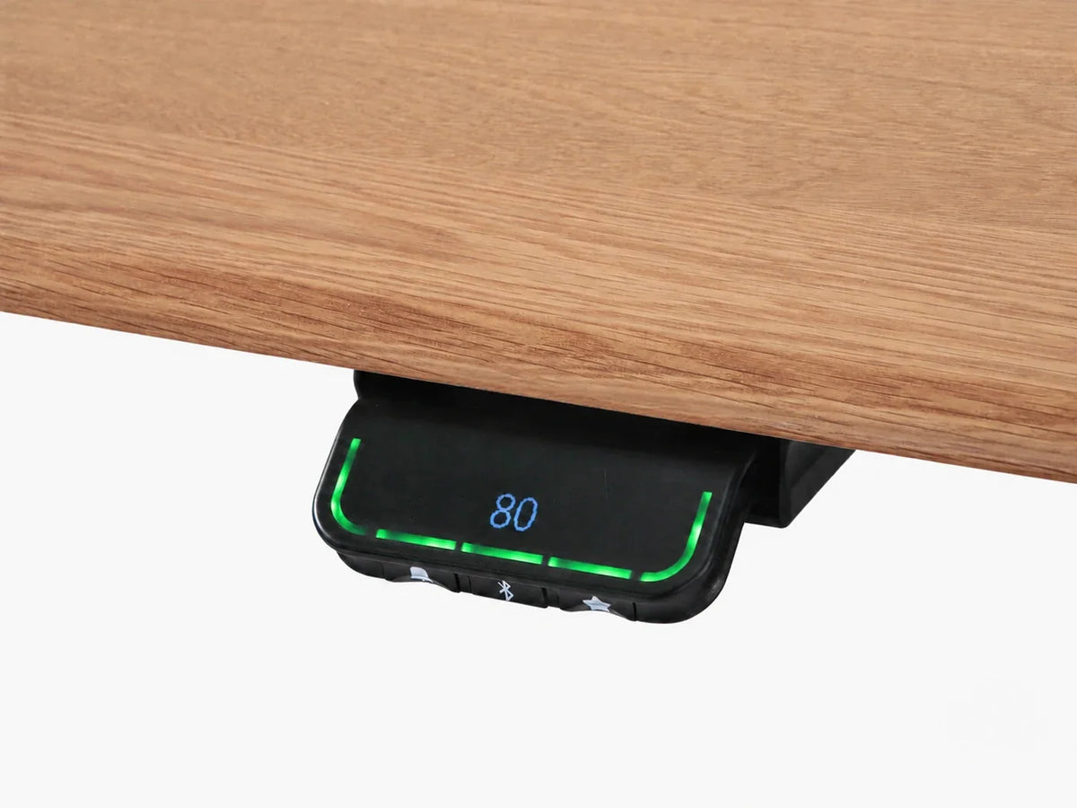 Under-edge paddle controller mounted beneath the solid white oak desktop