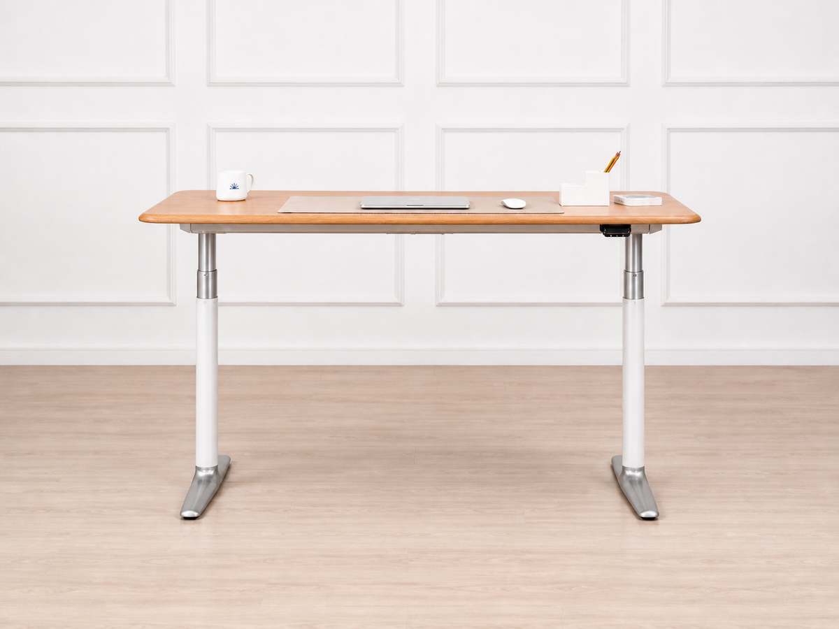 Solid white oak standing desk shown from the front in a bright home workspace