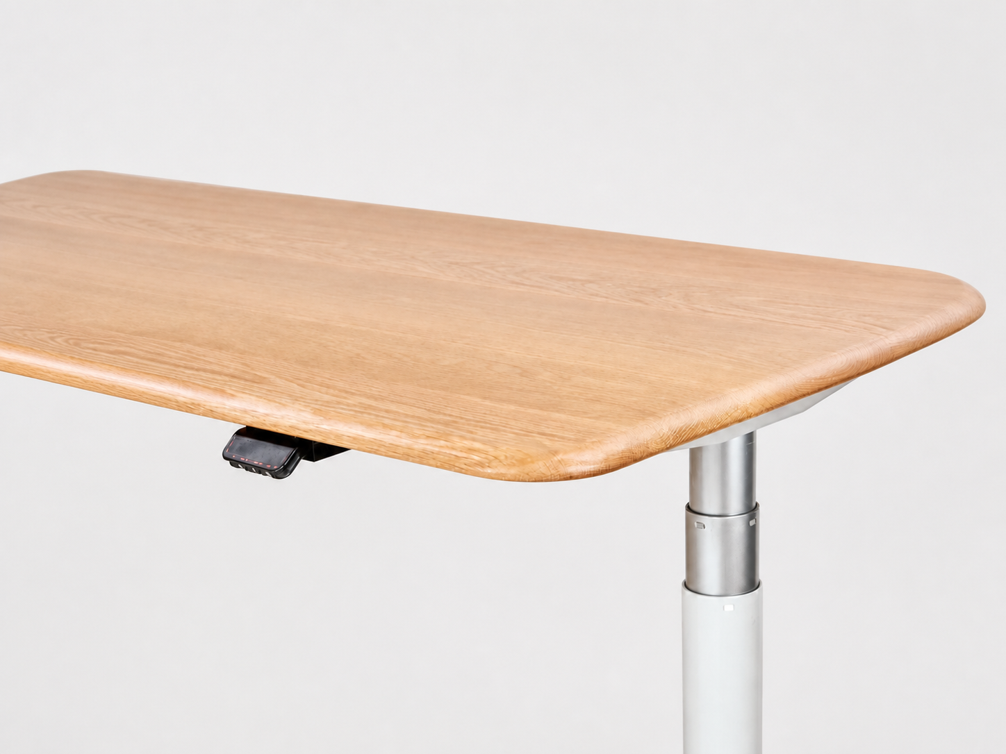 Solid white oak desktop showing its eased front edge and rounded corner