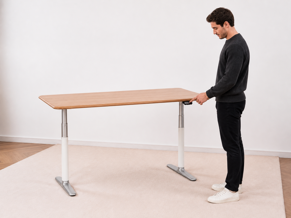Person using the under-edge paddle on the solid white oak standing desk