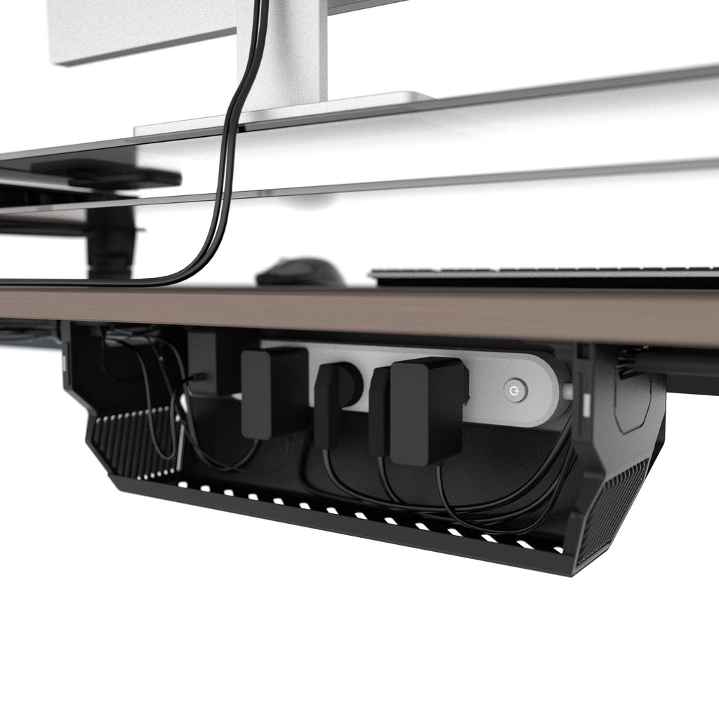 Open cable management box organizing a power strip, adapters, and cable slack