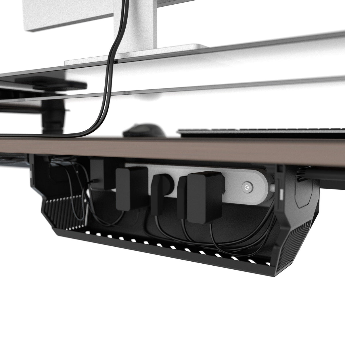 Open cable management box organizing a power strip, adapters, and cable slack