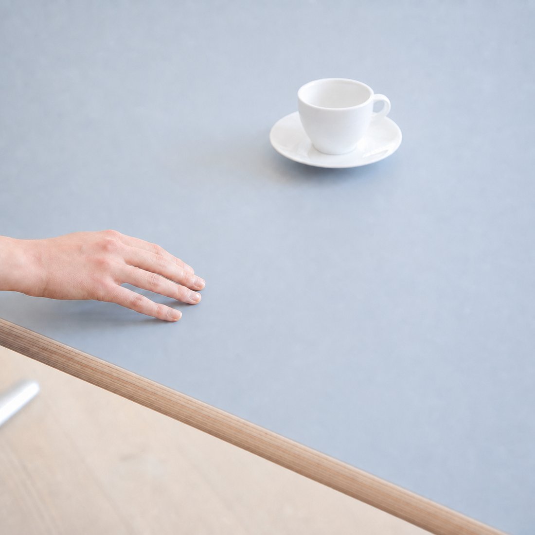 Hand moving across the Clear Sky Blue DacroSoft desktop surface