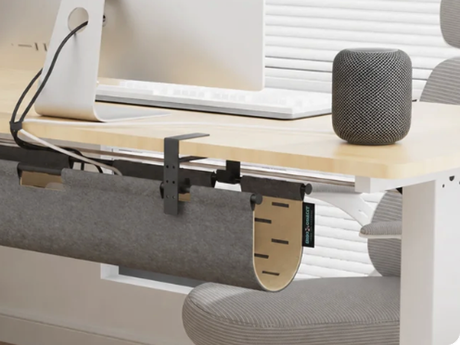 Gray felt privacy panel detail beneath a standing desk