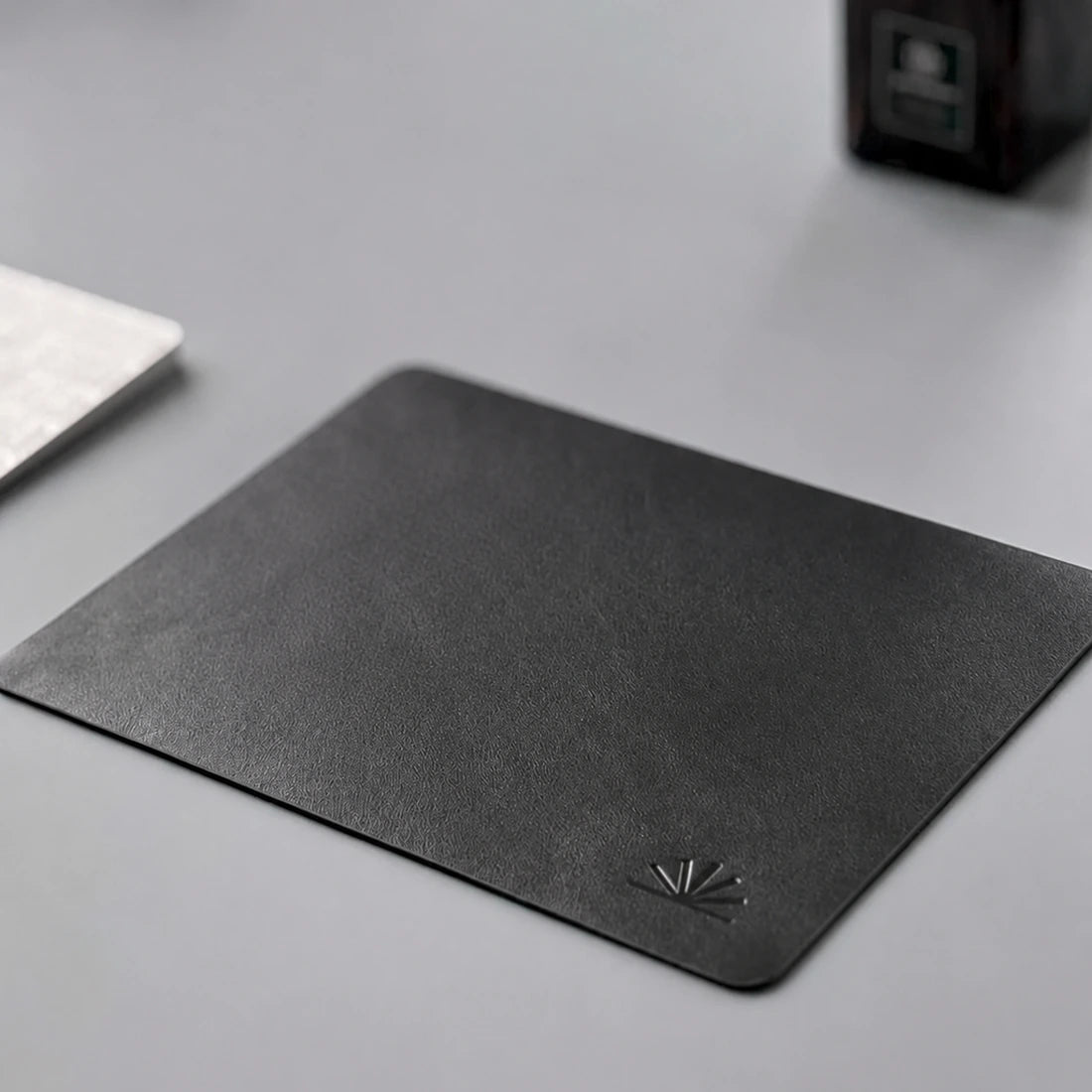 Compact Charcoal Black Napa mouse pad showing its fine grain and rounded oil-finished edge