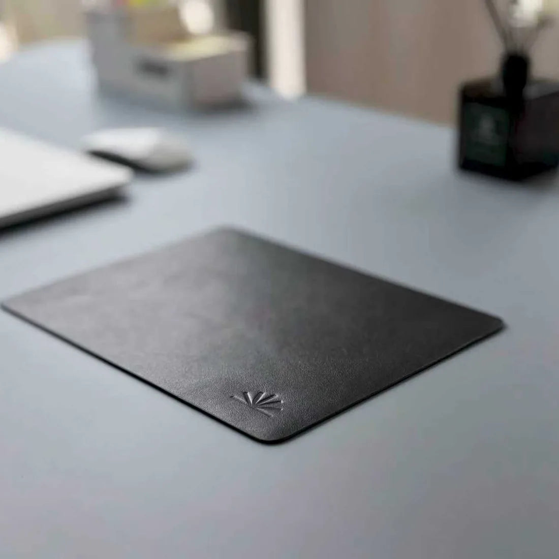 Compact Charcoal Black Napa mouse pad on a quiet desktop