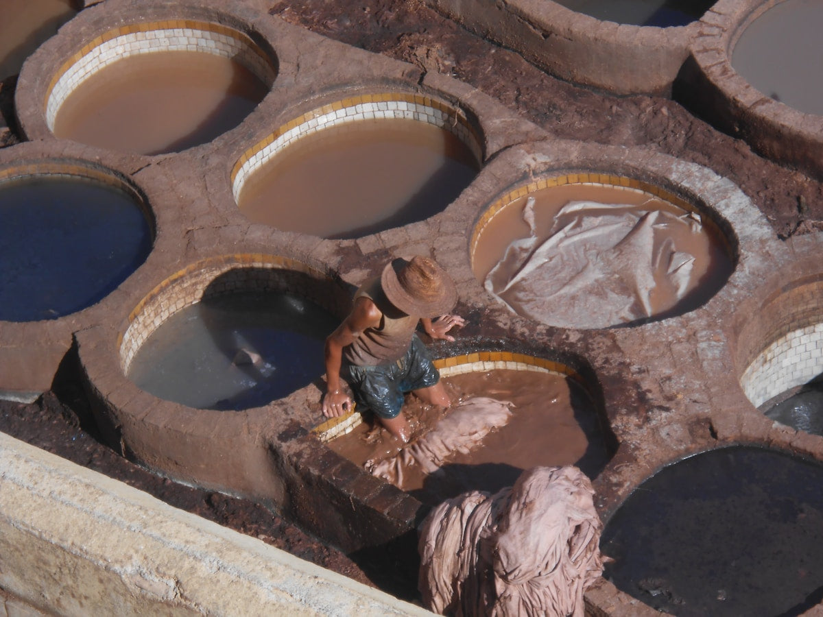 Traditional vegetable-tanning vats with hides being processed