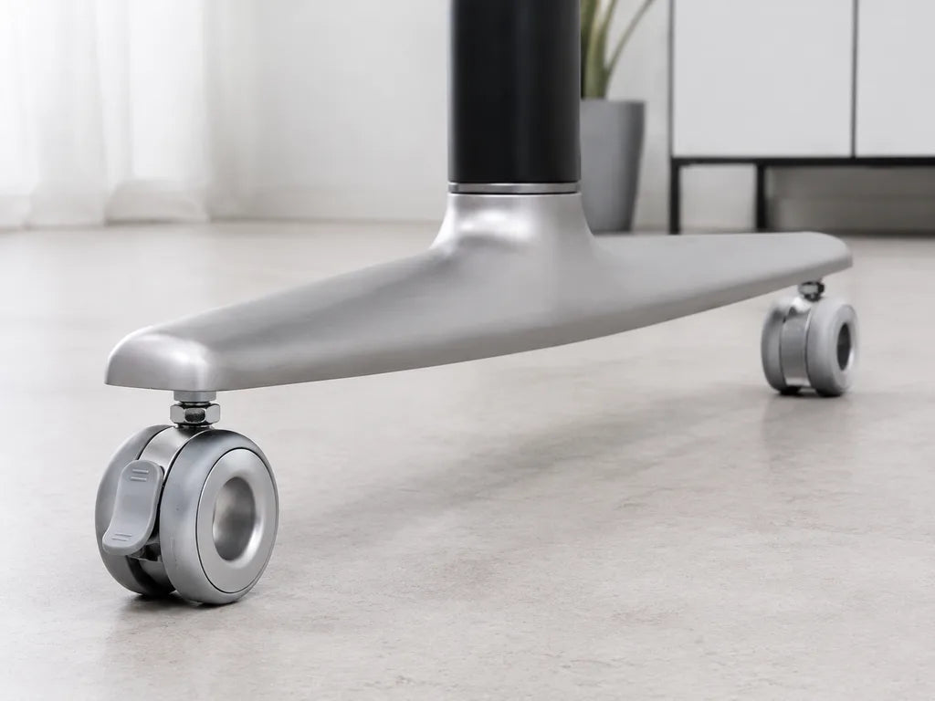 Locking and non-locking Standing Desk Casters installed at opposite ends of a desk foot